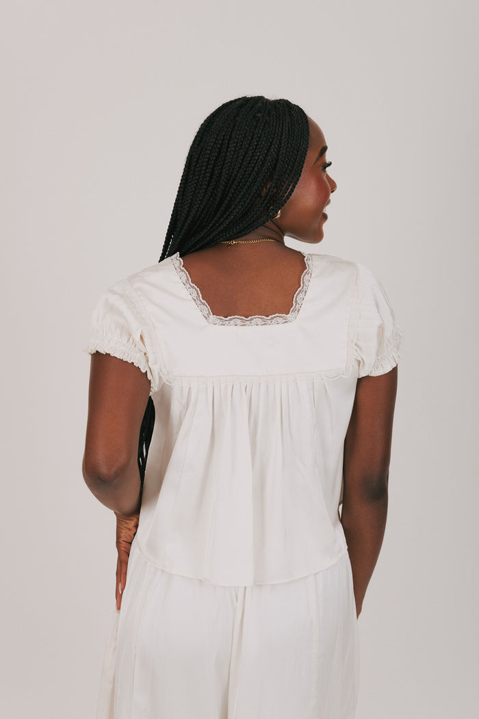 white v neck top with lace detailing back