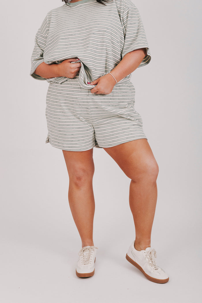 sage striped fleece shorts with pockets and an elastic waistband