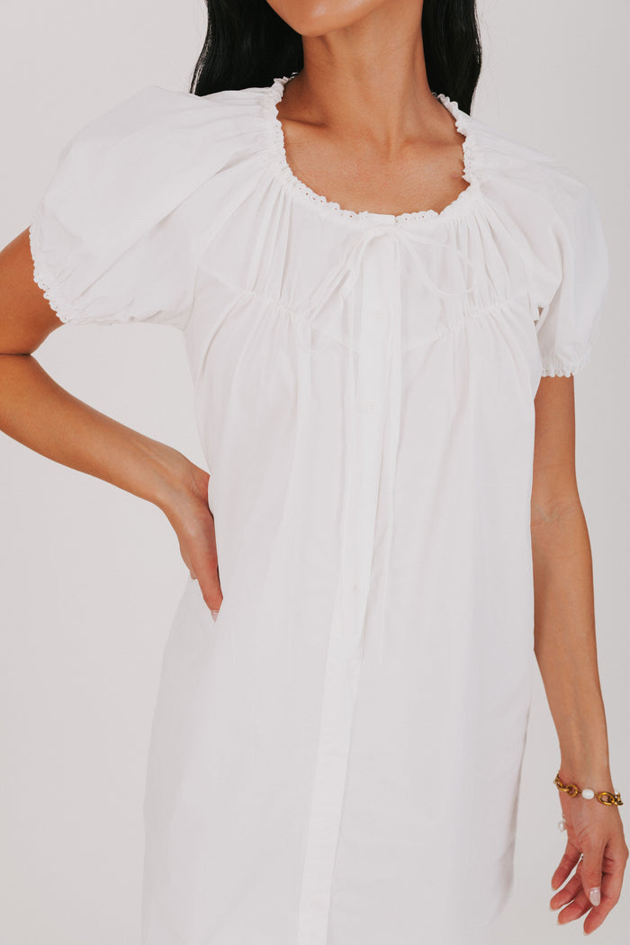 white mini dress with puff sleeves close up