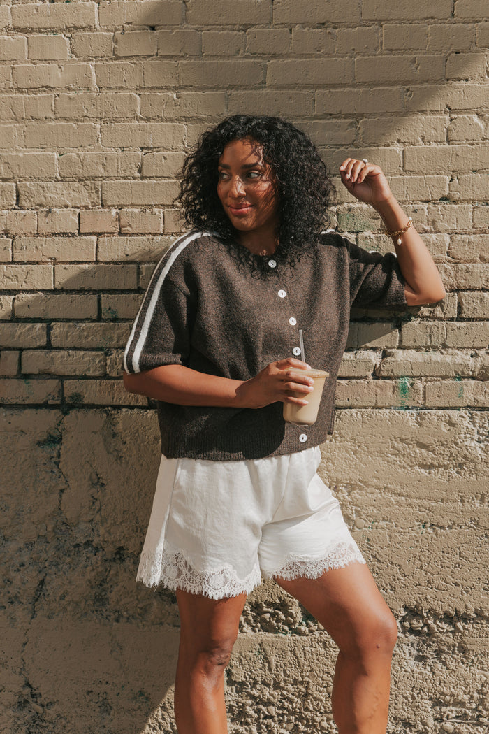 brown short sleeve cardigan with stripes on shoulders lifestyle