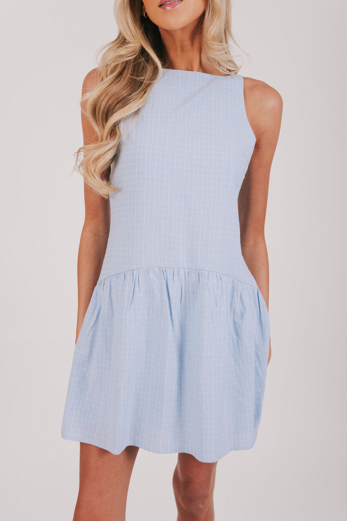 Light blue knee length sleeveless dress with a drop waist and boat neckline