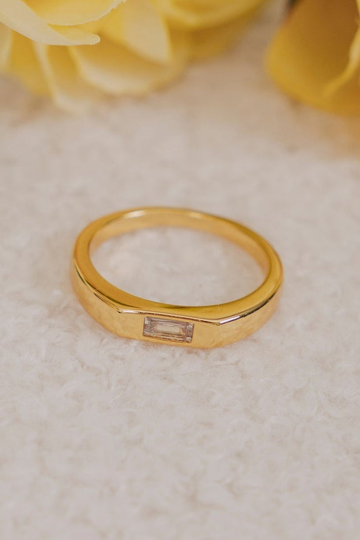 gold band ring with a cubic zirconia center