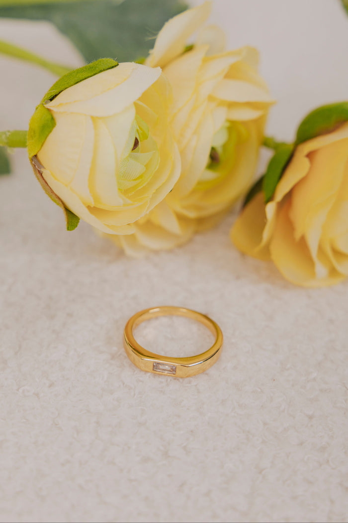 gold band ring with a cubic zirconia center