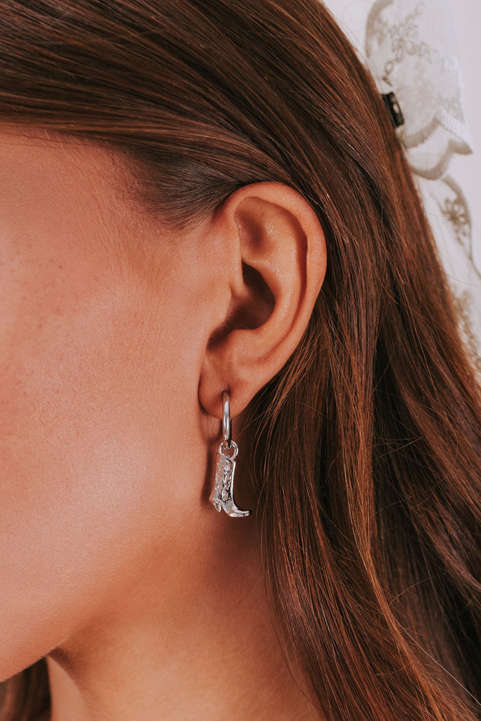 silver hoop earring with cowboy boot dangle
