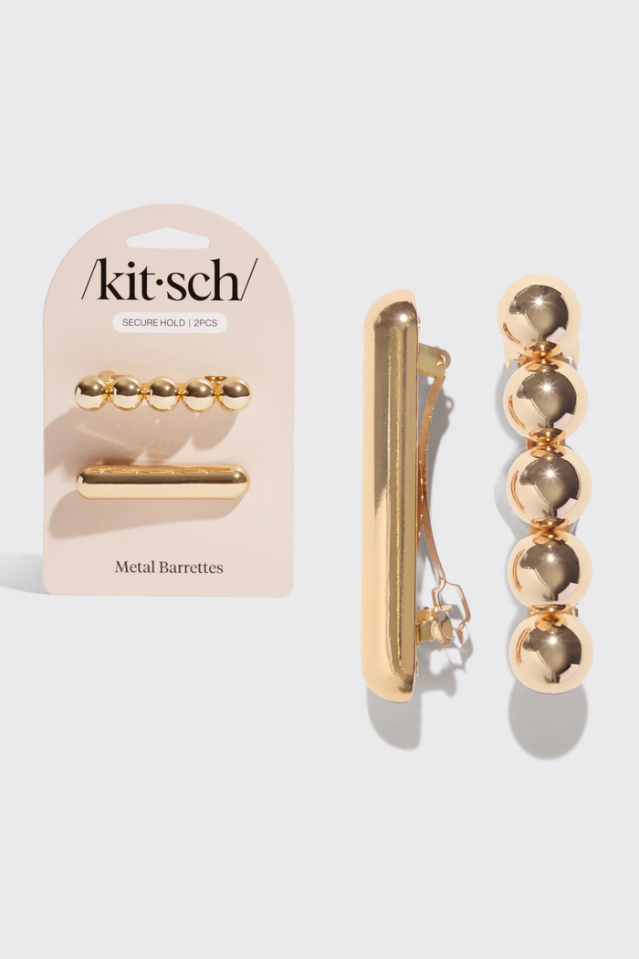 Metal barrettes with packaging labeled 'kitsch' on a white background