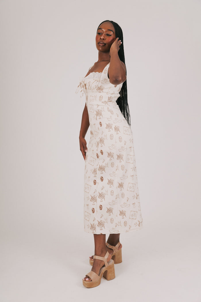 cream dress with brown print and lace detailing side