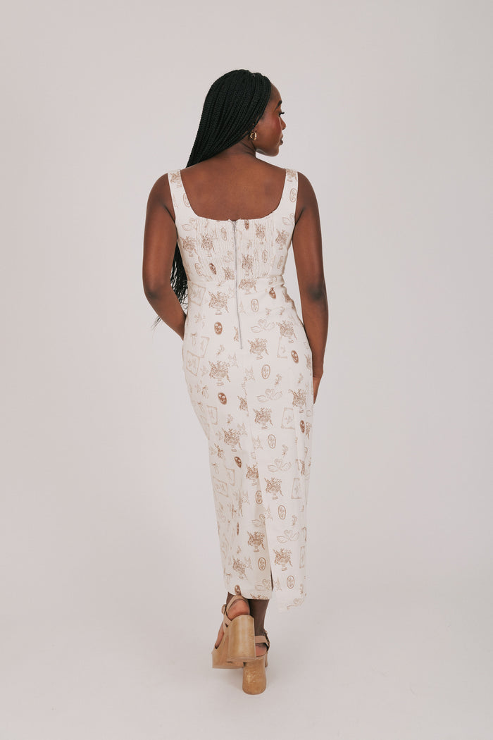 cream dress with brown print and lace detailing back