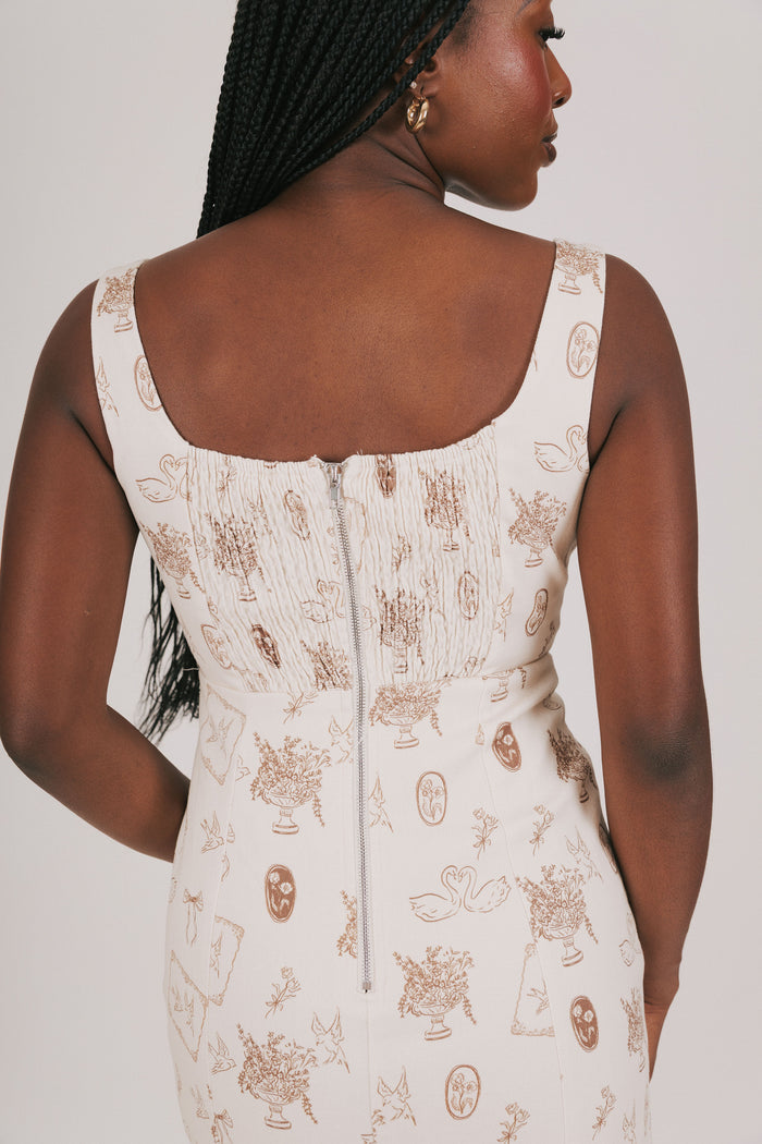 cream dress with brown print and lace detailing back close up