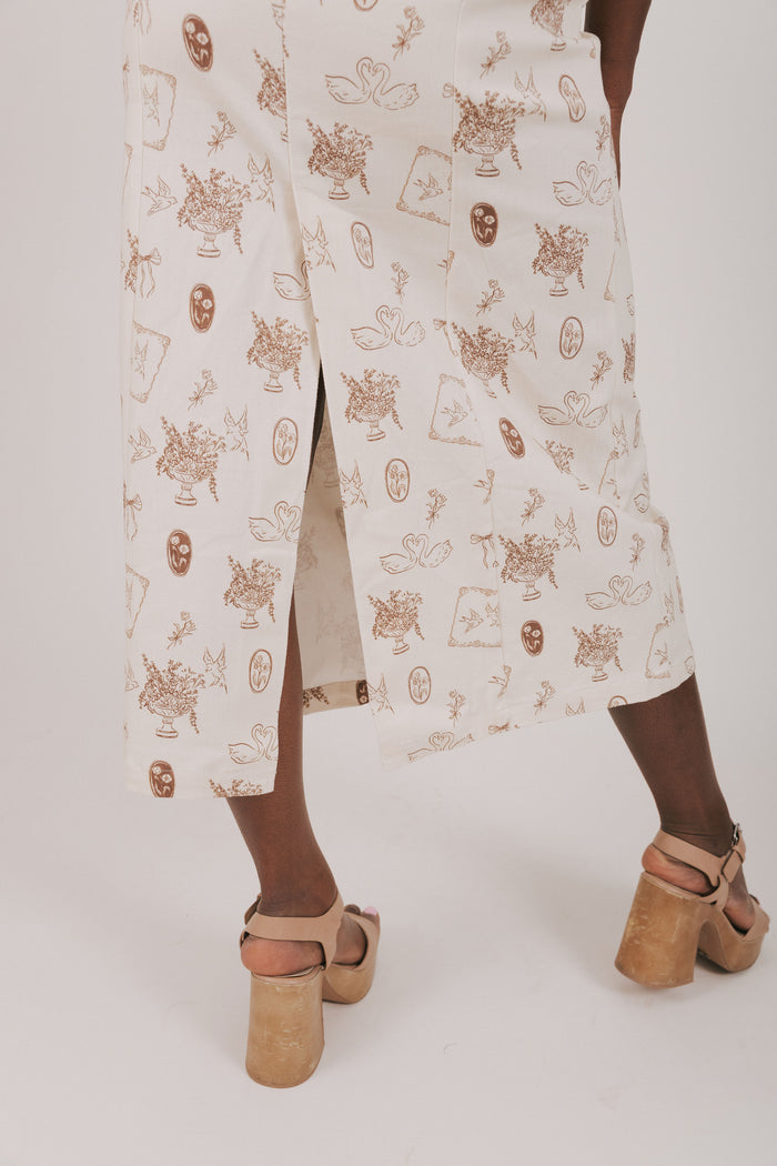 cream dress with brown print with lace detailing hemline