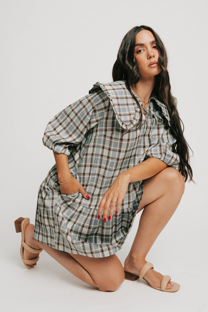 blue plaid mini dress with collar and puff sleeves pose