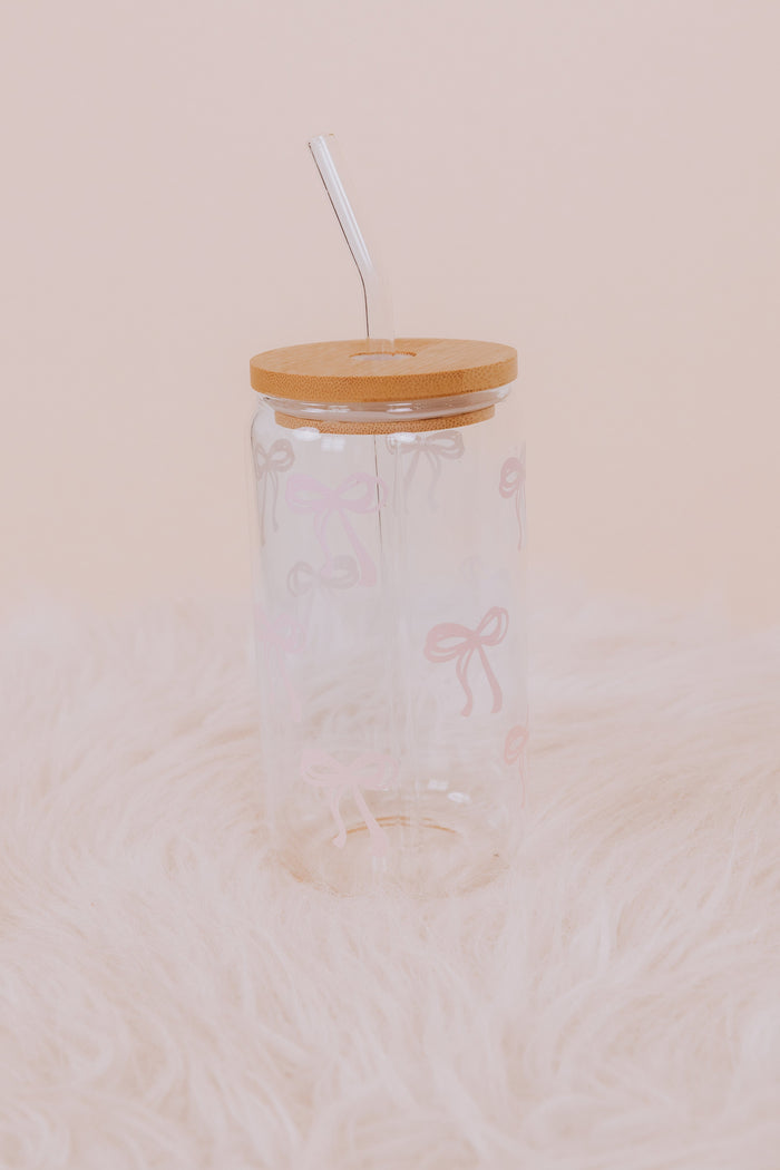 Clear glass tumbler with wooden lid and straw with pink bow details