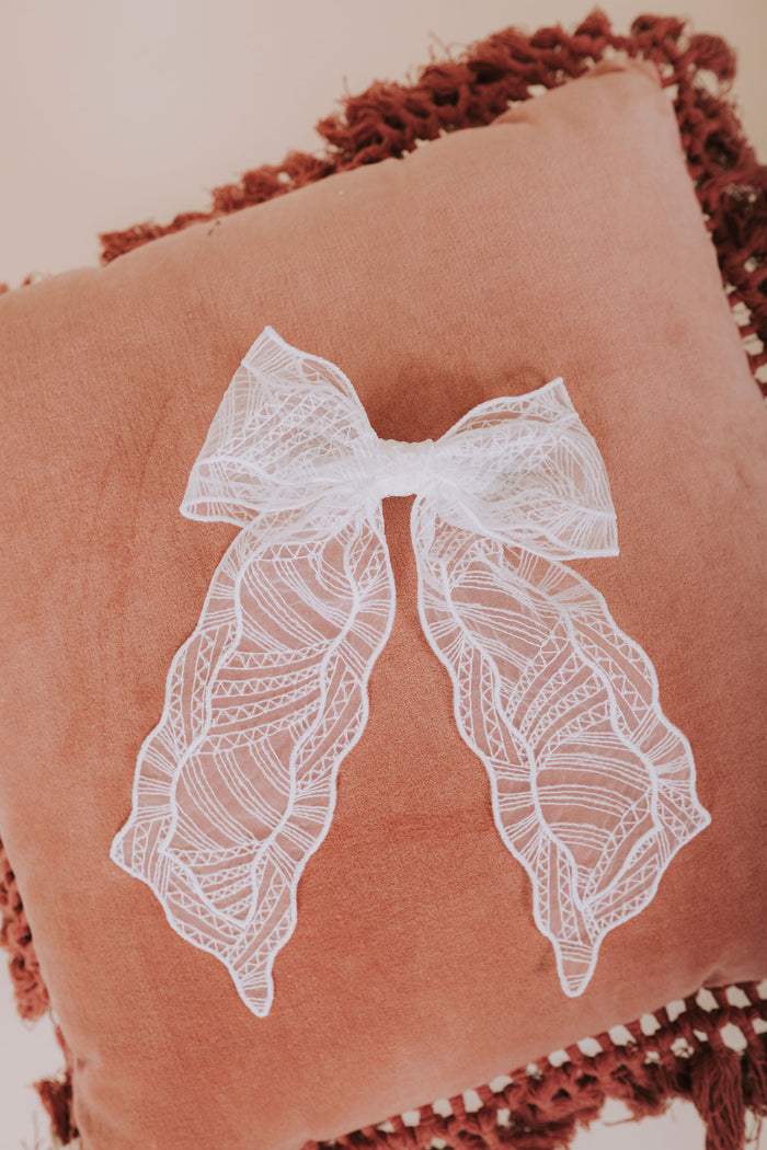 white mesh textured bow flatlay