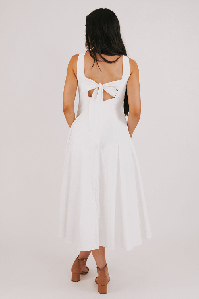 white midi dress with knot and keyhole back