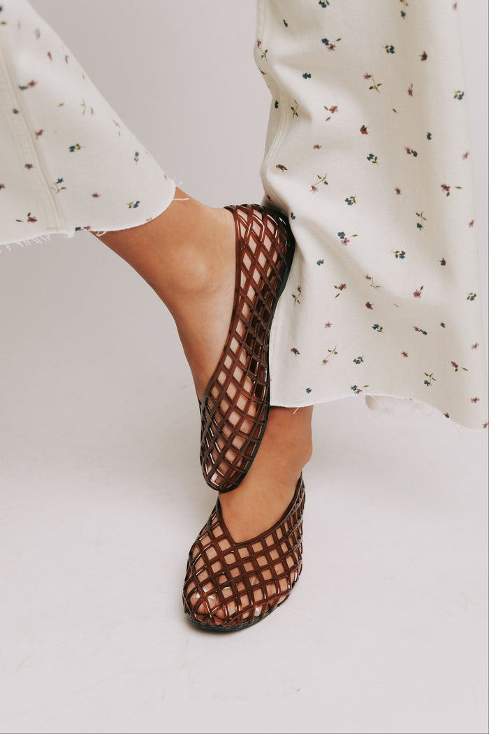 mia brown jelly flats pose