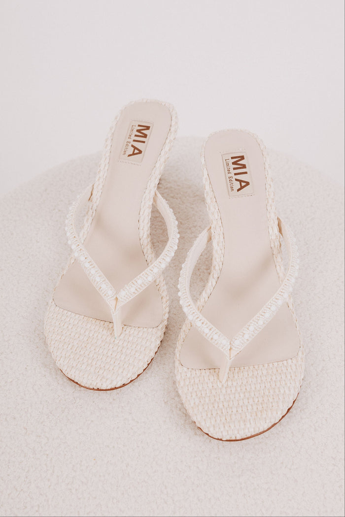 white woven heels with pearl details