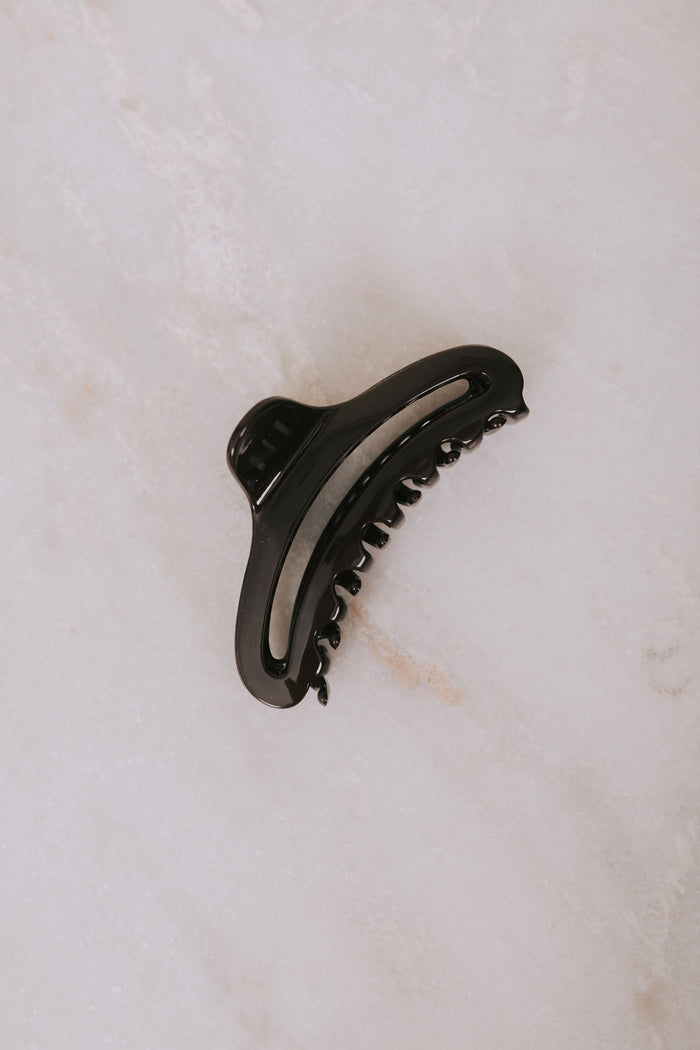 brown curved claw clip flatlay
