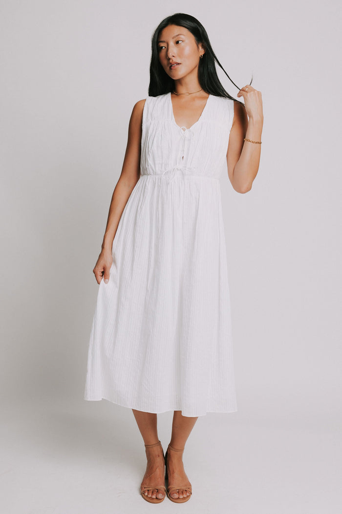 white sleeveless midi dress with bows on bodice