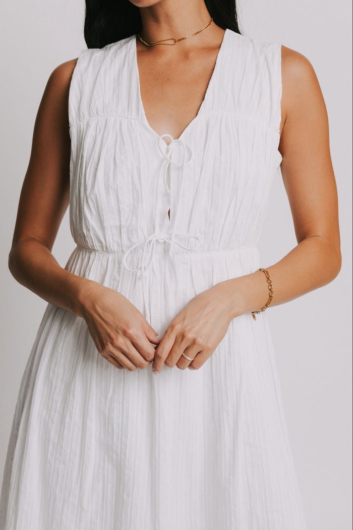 white sleeveless midi dress with bows on bodice close