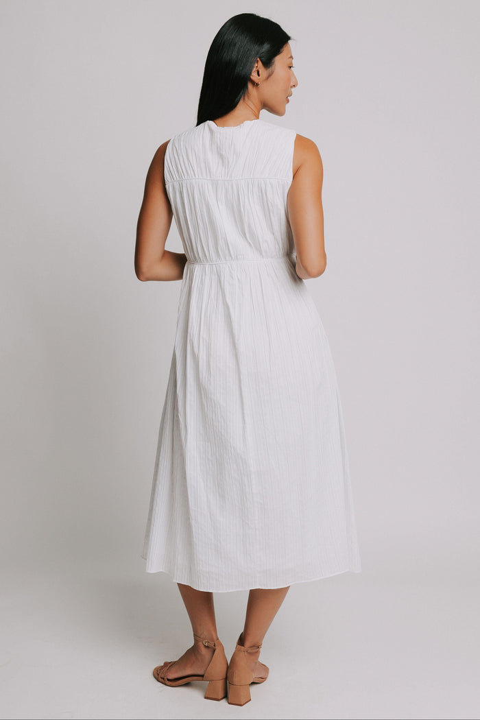 white sleeveless midi dress with bows on bodice back