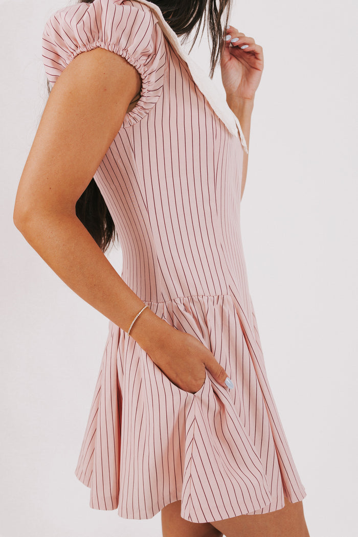 pink striped mini dress with white collar and puff sleeves pockets