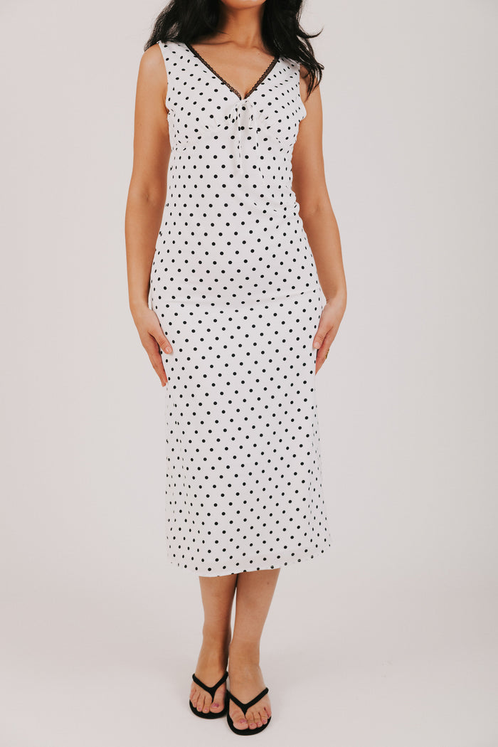 white v neck dress with black polka dots