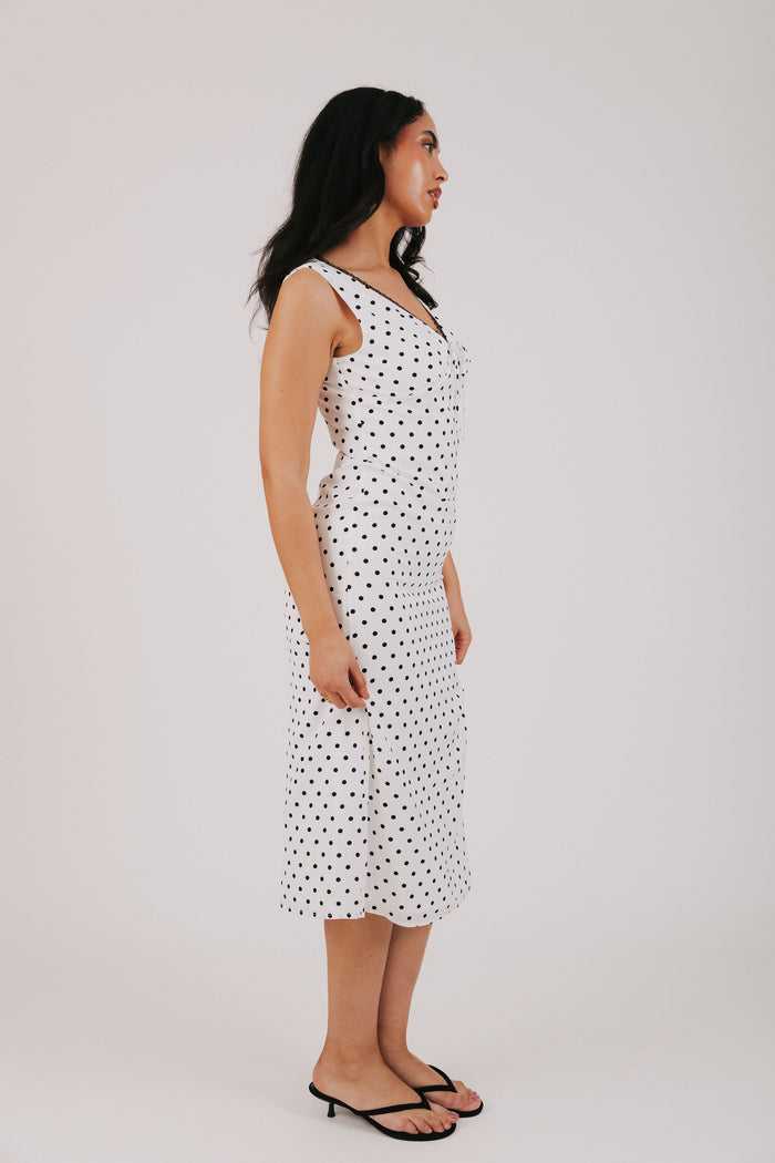 white v neck dress with black polka dots