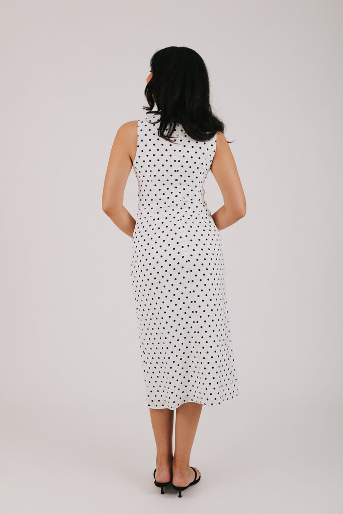 white v neck dress with black polka dots