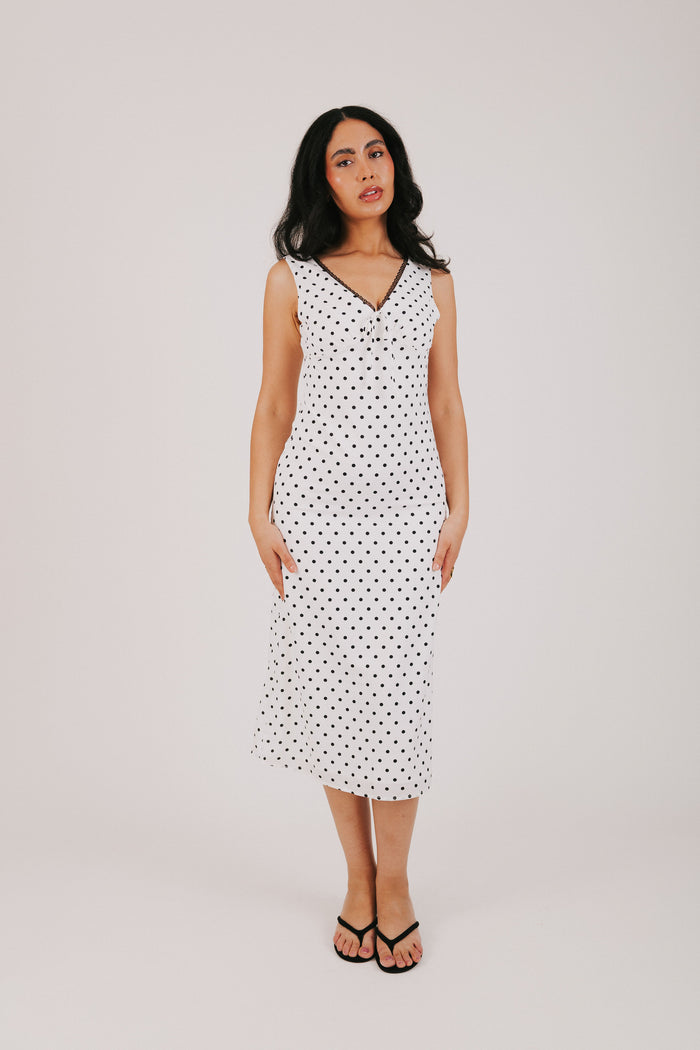 white v neck dress with black polka dots