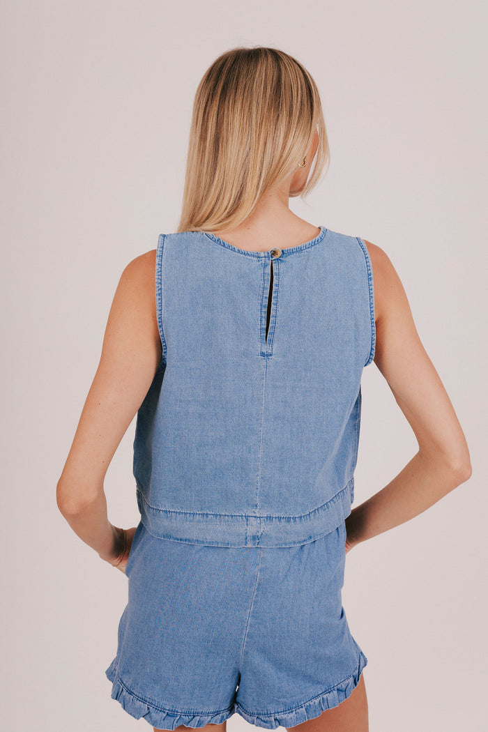 Plain denim sleeveless blouse with a back keyhole and baggy fit.