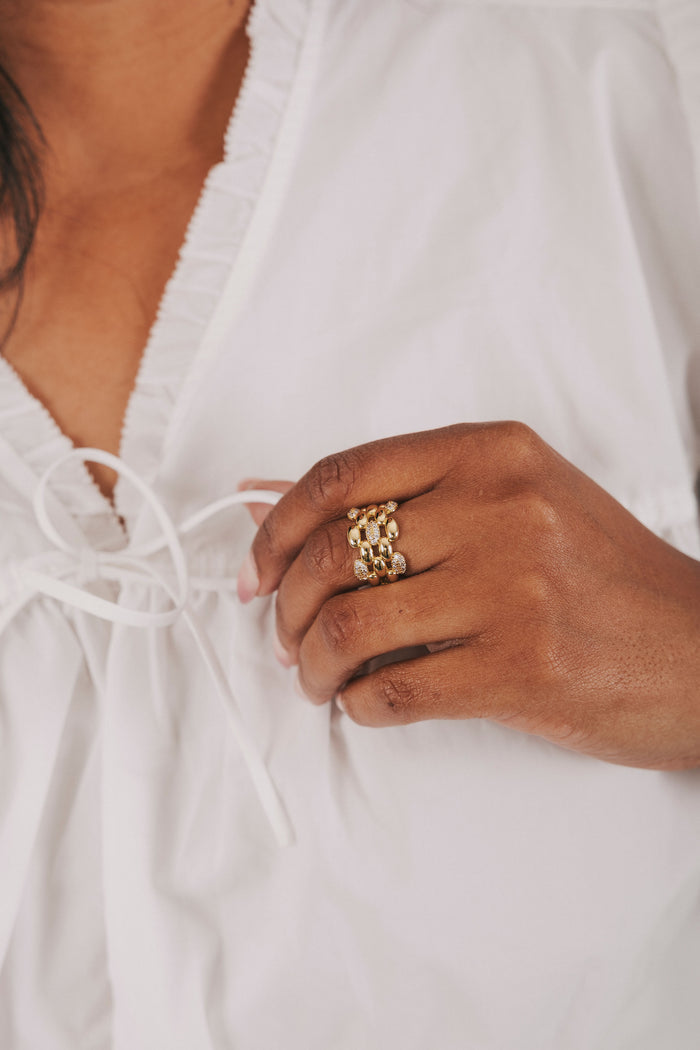 gold textured ring with cubic zirconia inlays