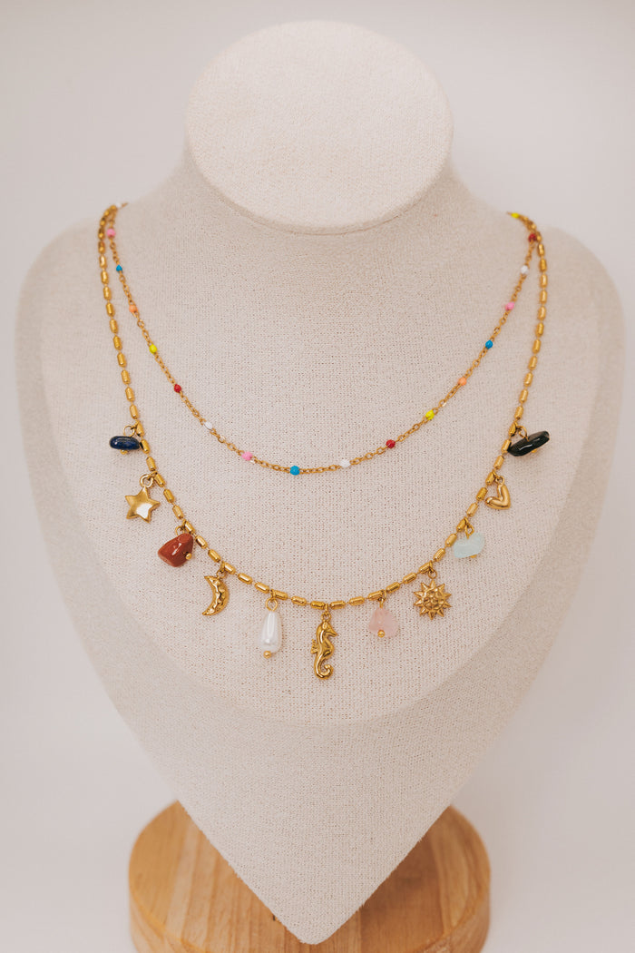 layered necklace with charms and gemstones