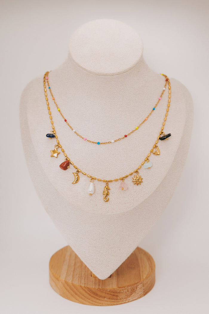 layered necklace with charms and gemstones