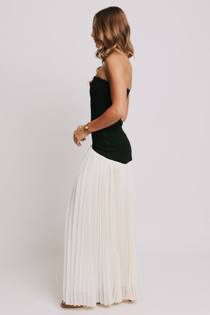 strapless maxi dress with black bodice and white pleated skirt side