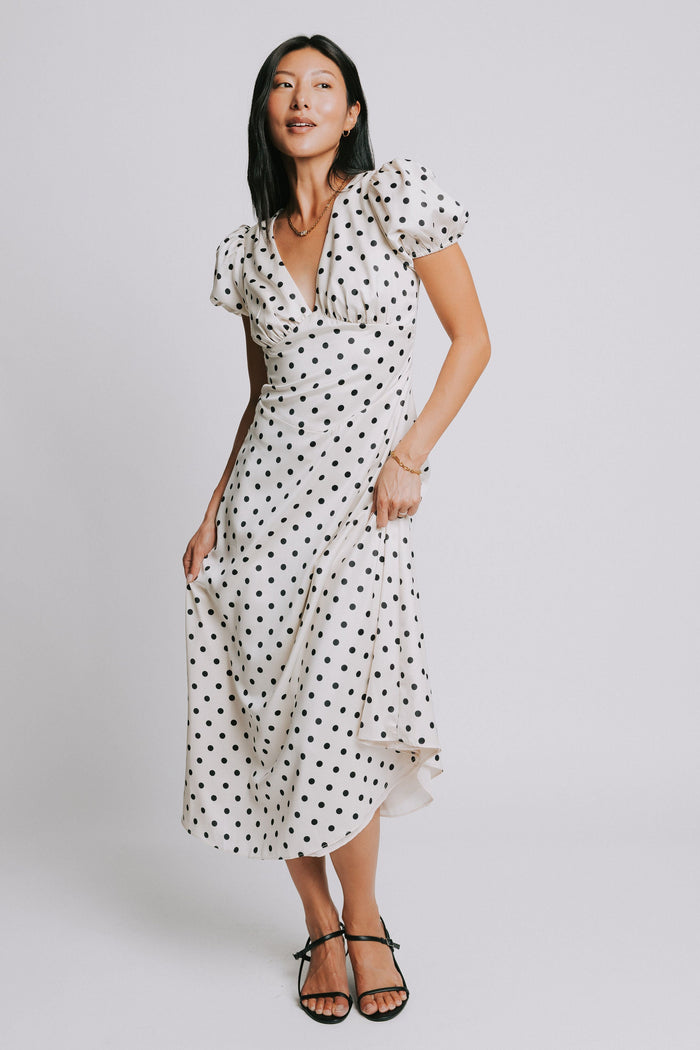 cream and black polka dot dress with v neck and puffed sleeves