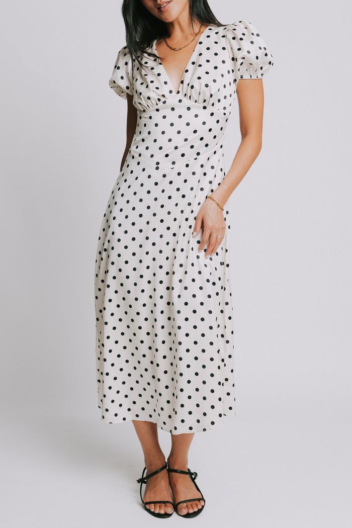 cream and black polka dot dress with v neck and puffed sleeves