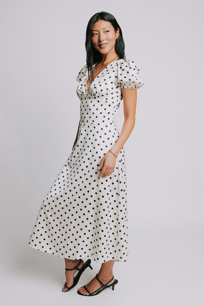 cream and black polka dot dress with v neck and puffed sleeves
