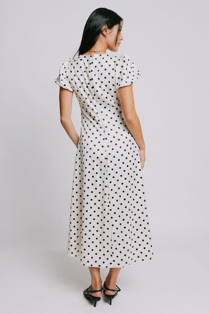 cream and black polka dot dress with v neck and puffed sleeves
