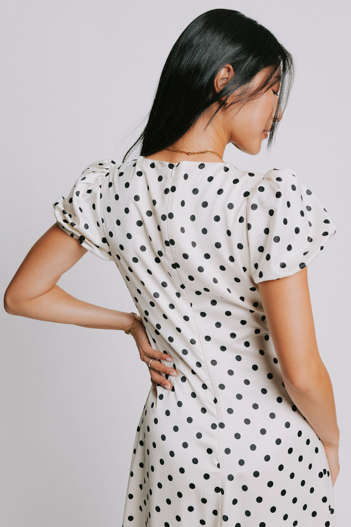cream and black polka dot dress with v neck and puffed sleeves back close