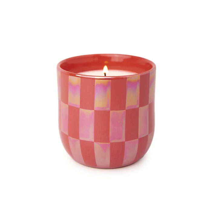 Candle in a red checkered container on a white background