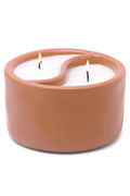 Ceramic candle holder with a candle inside on a white background