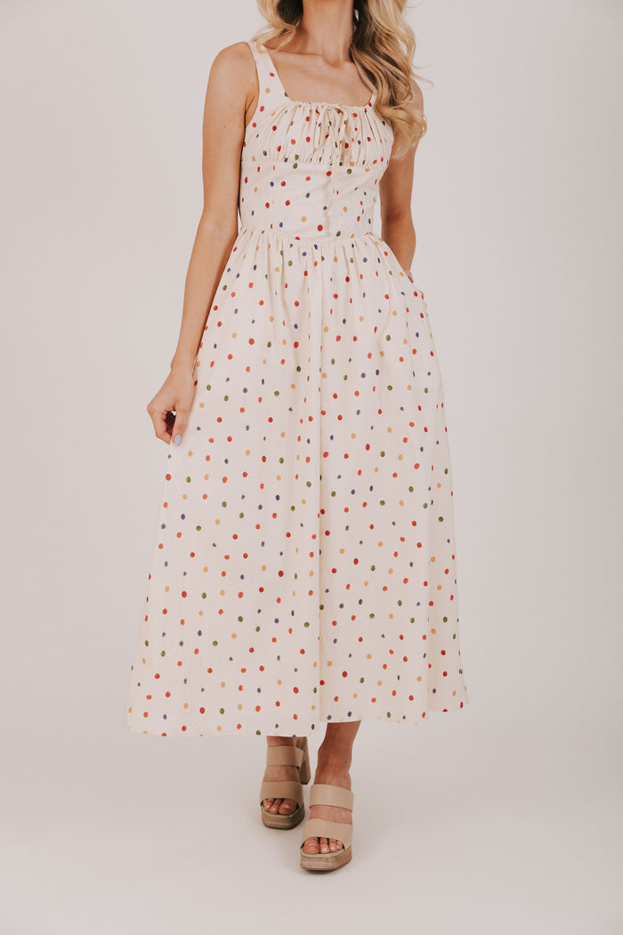 cream dress with multicolored polka dots