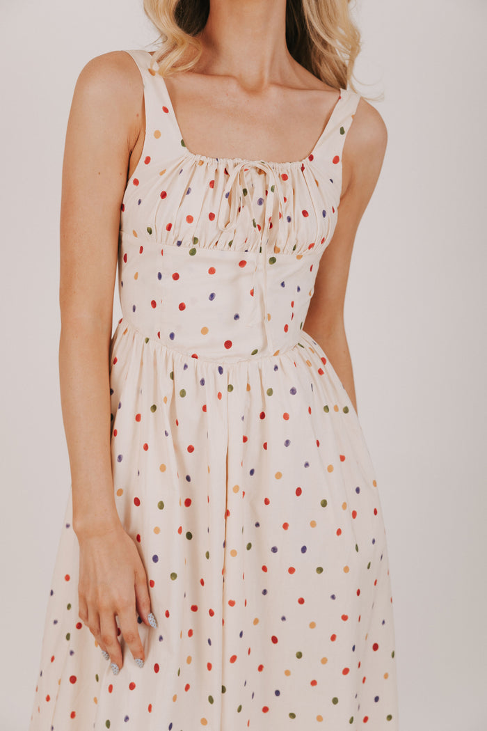 cream dress with multicolored polka dots