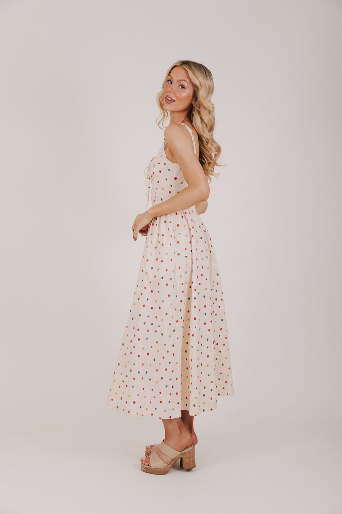 cream dress with multicolored polka dots