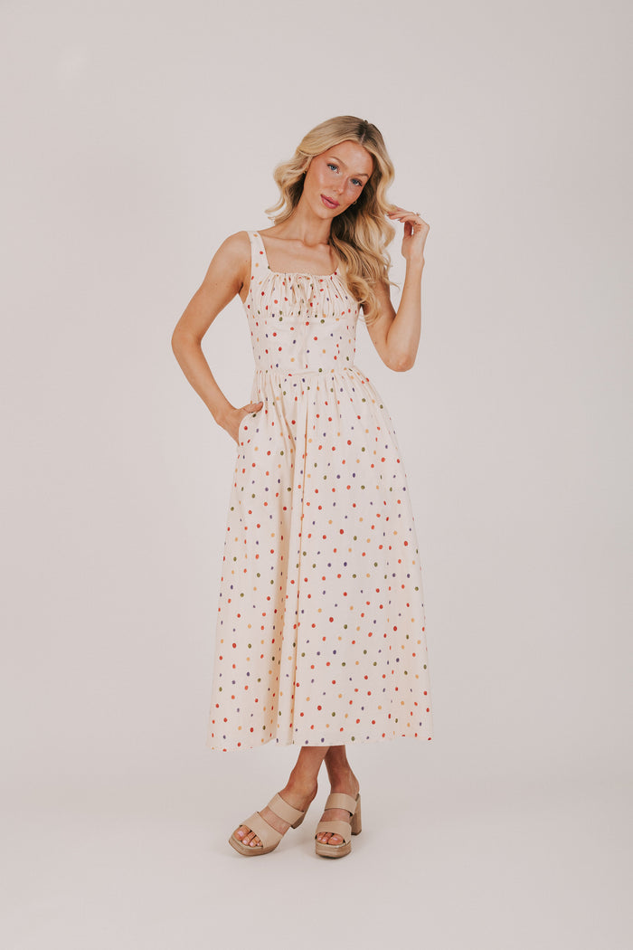 cream dress with multicolored polka dots