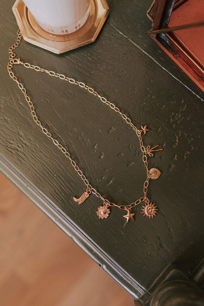 gold chain charm necklace display
