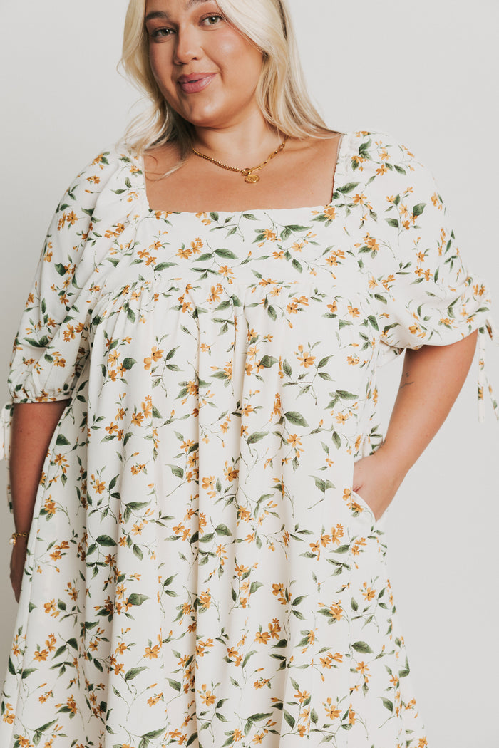 knee length floral dress with square neck and puff sleeves front