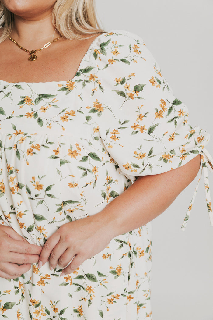 knee length floral dress with square neck and puff sleeves close