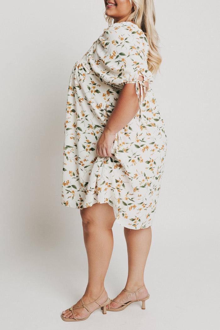 knee length floral dress with square neck and puff sleeves side
