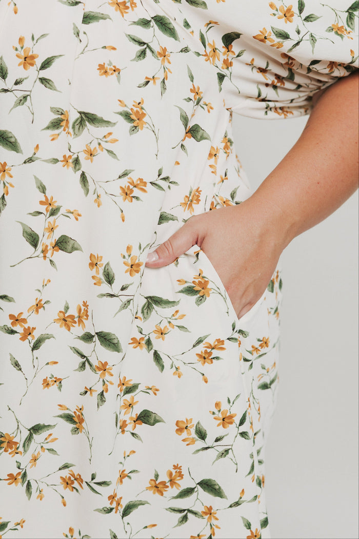 knee length floral dress with square neck and puff sleeves pockets