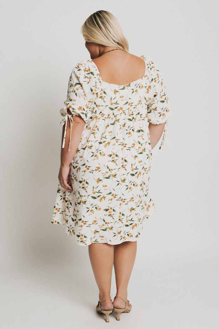knee length floral dress with square neck and puff sleeves back